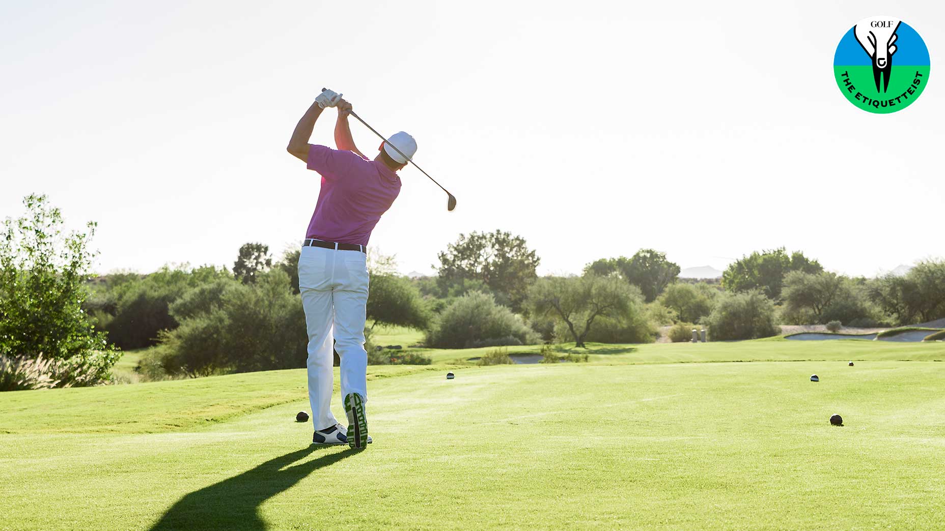 a golfer tees off on the golf course