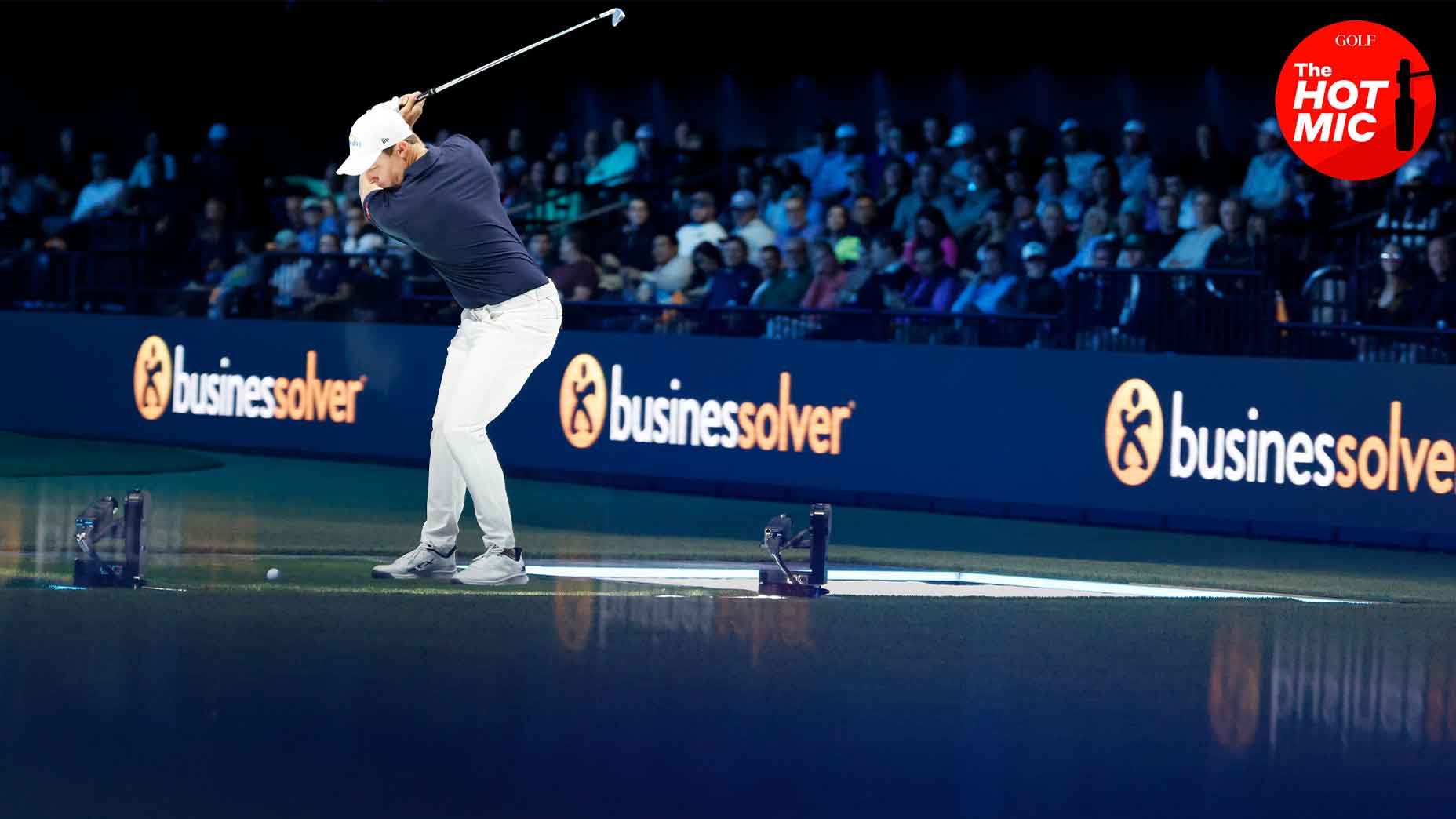 Matt Fitzpatrick swings [KingKong_APP金刚生态官网[KingKong_APP金刚生态官网] club at the TGL's arena in navy shirt and white hat